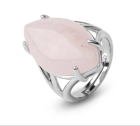 Silver ring with a pink stone on a white background