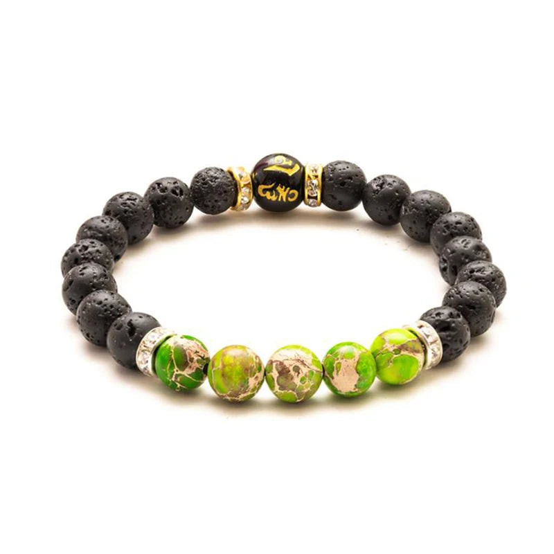 Bracelet with black and green beads on a white background