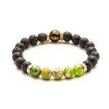 Bracelet with black and green beads on a white background