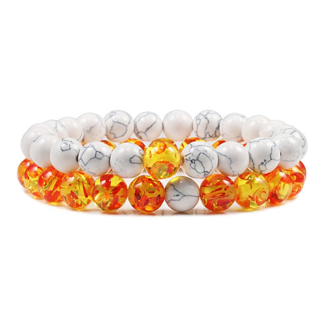 Beaded bracelet with white, orange, and yellow beads on a white background