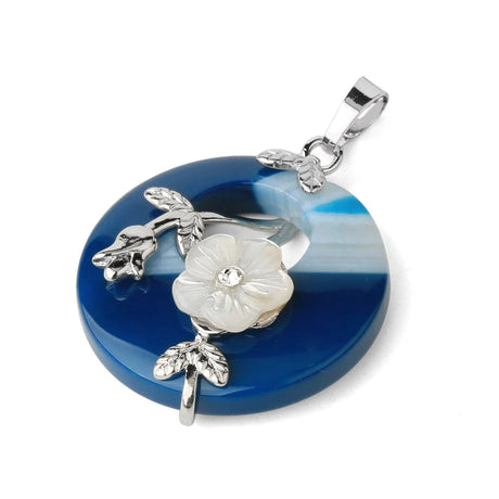 Blue circular pendant with silver floral design on a white background