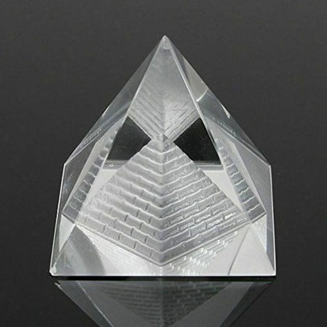 Clear pyramid-shaped crystal on a black background
