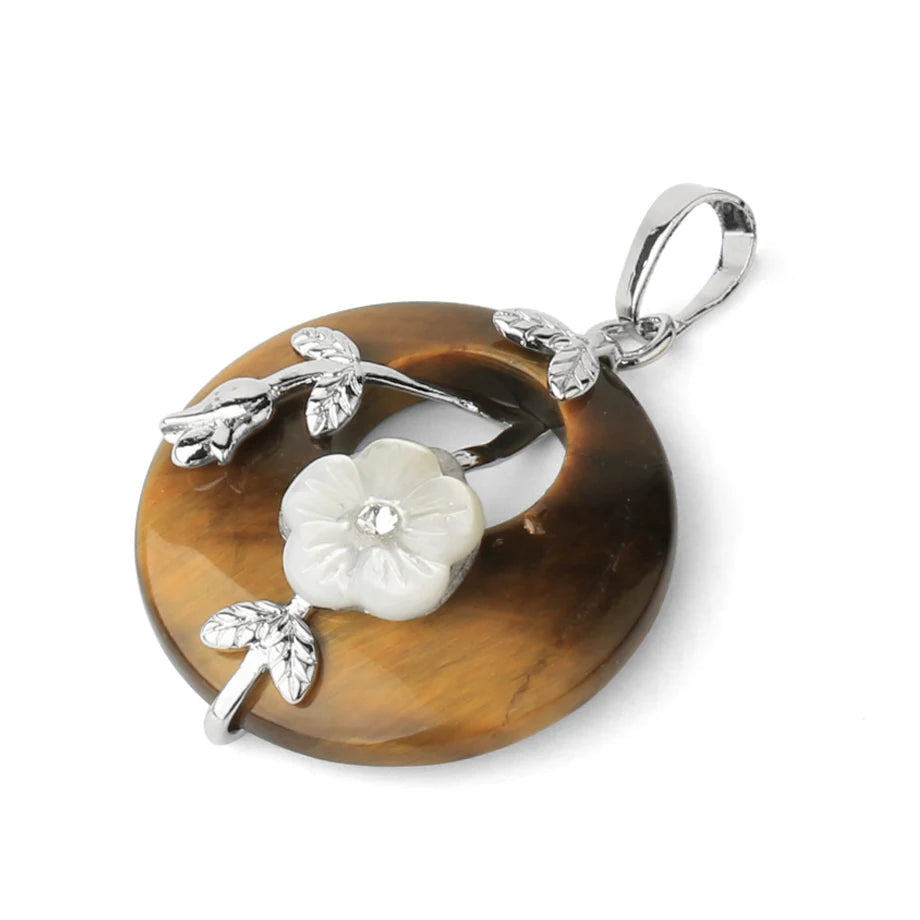 Jewelry pendant with floral design on a brown stone background