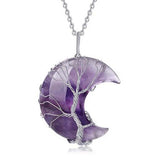 Purple crescent moon-shaped pendant with silver tree design on a white background
