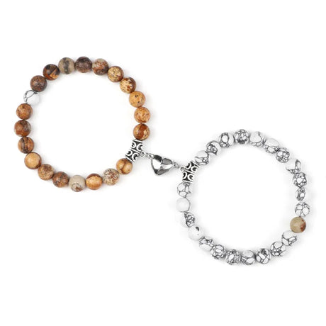 Two bracelets, one with brown beads and the other with silver charms, on a white background.