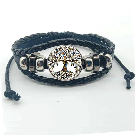 Black braided leather bracelet with silver tree of life charm on a white background