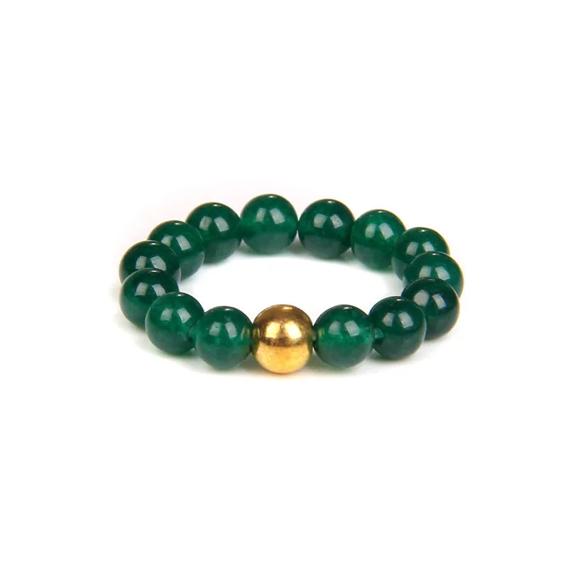 Green beaded bracelet with a gold accent on a white background