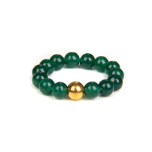 Green beaded bracelet with a gold accent on a white background