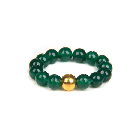 Green beaded bracelet with a gold accent on a white background