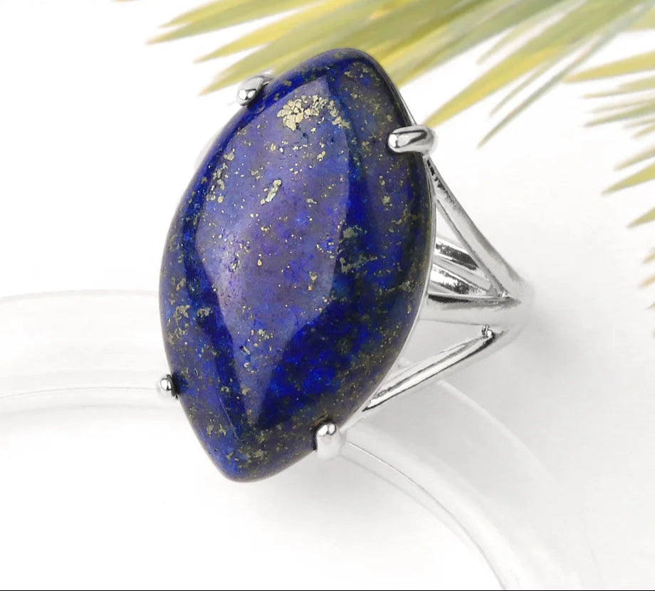 Lapis lazuli ring with gold specks on a white background