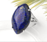 Lapis lazuli ring with gold specks on a white background