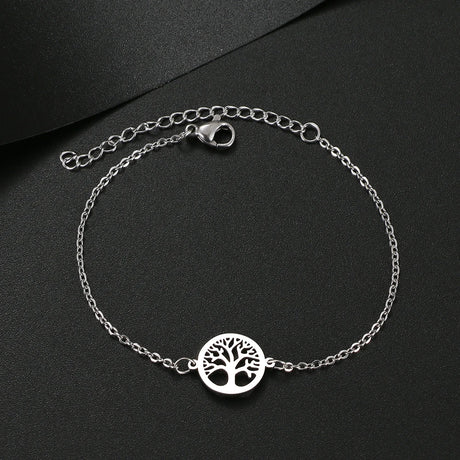 Silver bracelet with tree of life charm on a black background