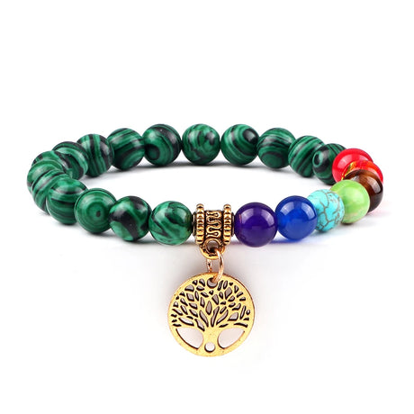 Multicolored beaded bracelet with a gold tree of life charm on a white background