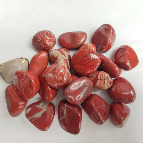 Collection of red marbled stones on a white background