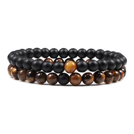Set of black and brown beaded bracelets on a white background