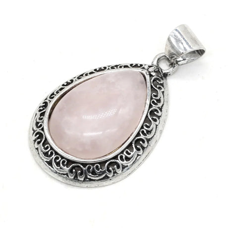 Silver pendant with a pink teardrop-shaped gemstone on a white background