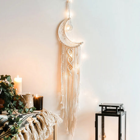 Decorative wall hanging with moon design in a room setting.