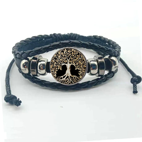 Black braided leather bracelet with a tree of life charm on a white background