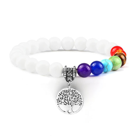 Bracelet with white beads and colorful beads featuring a tree of life charm on a white background