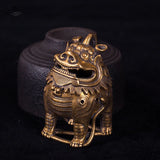 Bronze lion statue on a dark background