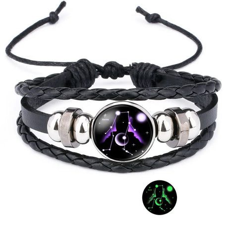 Black braided leather bracelet with a glowing purple and black star constellation design on a white background.