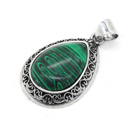 Teardrop-shaped pendant with green stone and silver frame on a white background