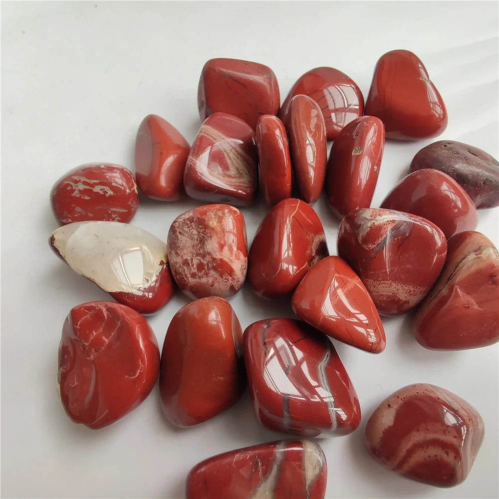 Collection of red marbled stones on a white background