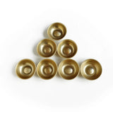 Set of gold bowls arranged in a pyramid formation on a white background