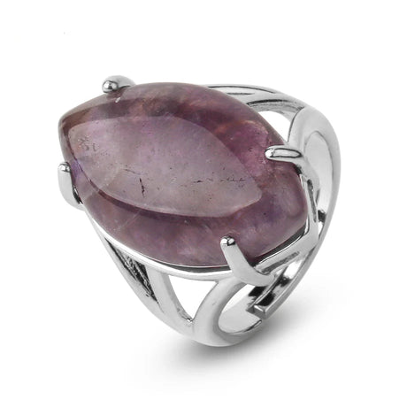 Silver ring with a large purple gemstone on a white background