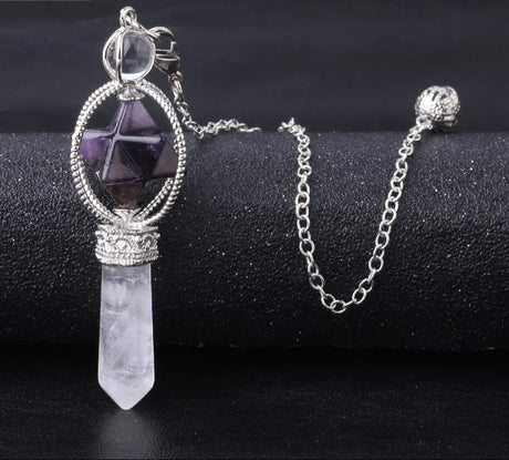 Crystal pendant necklace on a black surface with 'Cala Jewelry' logo.