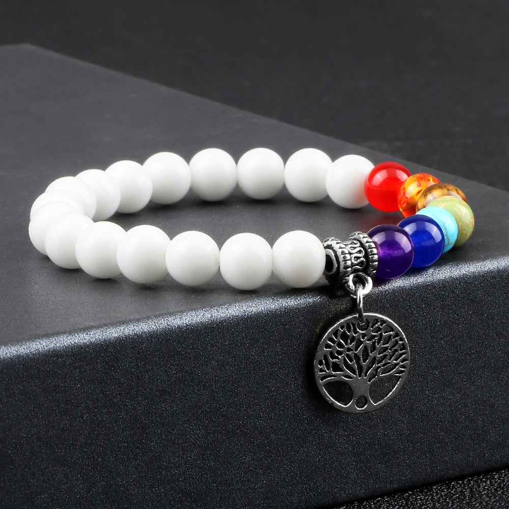 Bracelet with white beads and colorful accents on a black surface