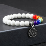 Bracelet with white beads and colorful accents on a black surface