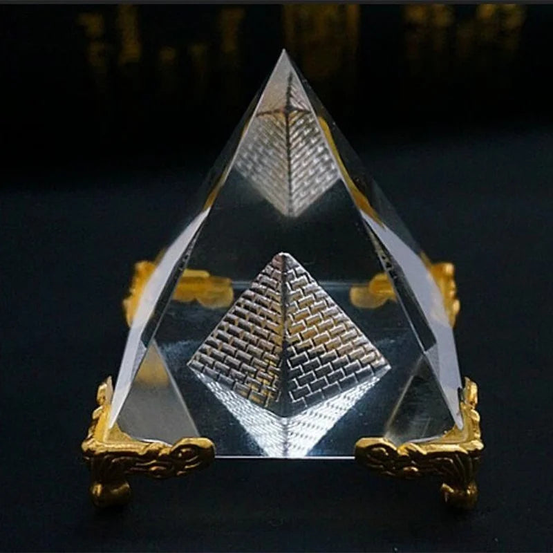 Crystal pyramid with gold base on a dark background