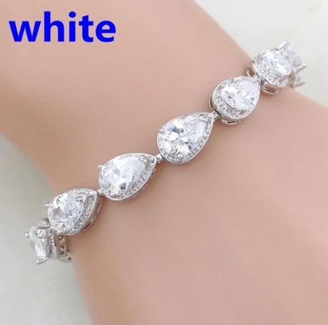 Silver bracelet with teardrop-shaped crystals on a white background