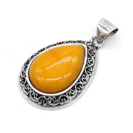 Silver pendant with a yellow teardrop-shaped gemstone on a white background