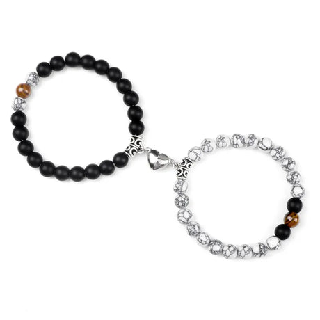 Two bracelets, one with black beads and the other with silver and multicolored beads, on a white background.