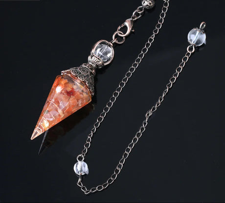 Crystal pendulum with chain on a black background, featuring Cila Jewelry logo.