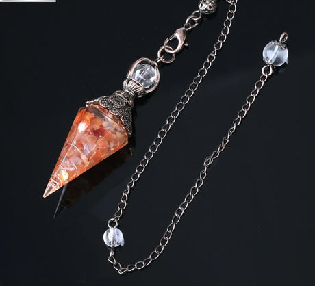 Crystal pendulum with chain on a black background, featuring Cila Jewelry logo.