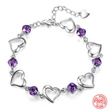 Silver bracelet with heart-shaped links and purple beads on a white background, featuring the brand 'ZDADAN'.