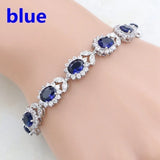 Silver bracelet with blue gemstones on a white background