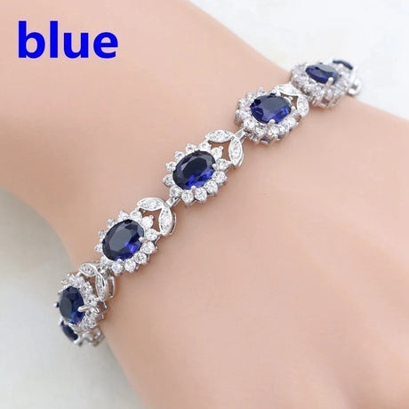 Silver bracelet with blue gemstones on a white background
