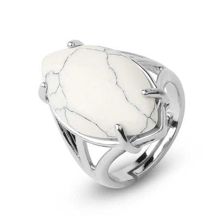 Silver ring with a large white stone on a white background