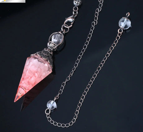 Crystal pendant necklace with pink gemstone on a dark background