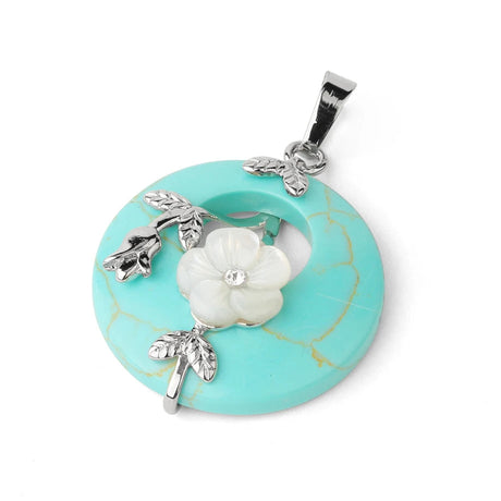 Turquoise pendant with floral design on a white background