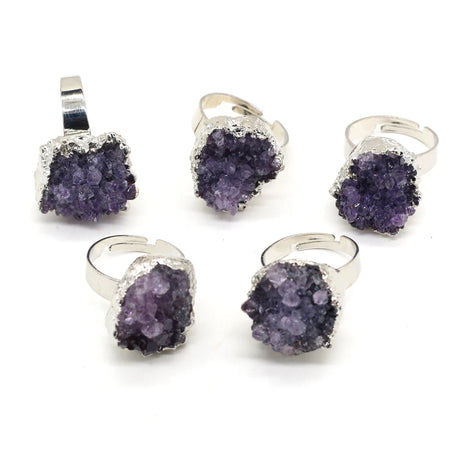 Set of purple crystal jewelry pieces with silver accents on a white background