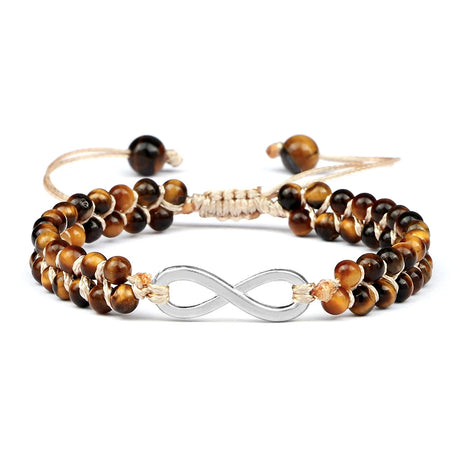 Set of tiger eye beaded bracelets with gold and silver accents on a white background