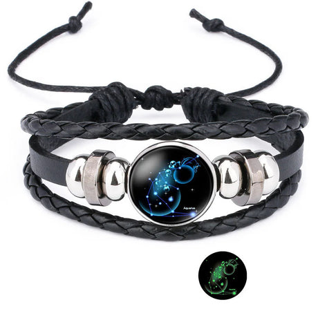 Black braided leather bracelet with silver accents and a glowing black stone on a white background.
