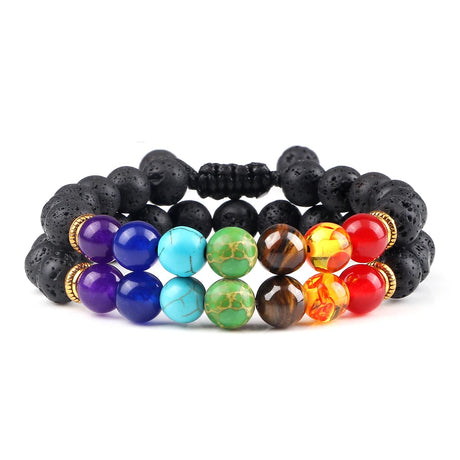 Multicolored beaded bracelet with black lava rock beads on a white background
