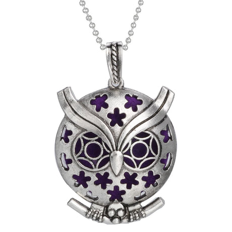 Silver owl pendant with purple accents on a white background