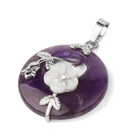 Purple amethyst pendant with silver floral designs on a white background